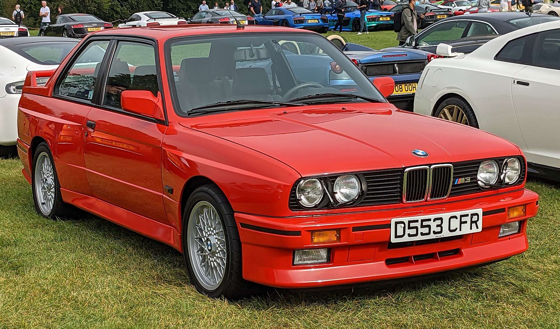 Red 1987 European-market BMW E30 M3 at a car show