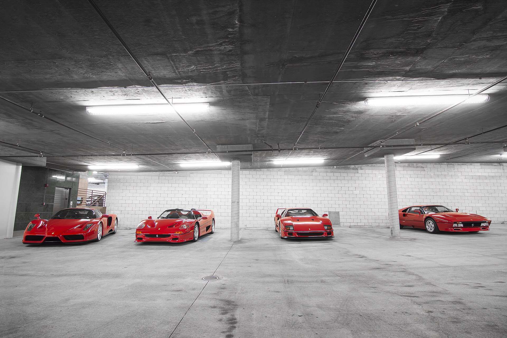 Ferrari 288 GTO, F40, F50 and Enzo parked in a row in a garage