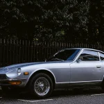 Silver 1972 Datsun 240Z parked outdoors, three-quarter front view
