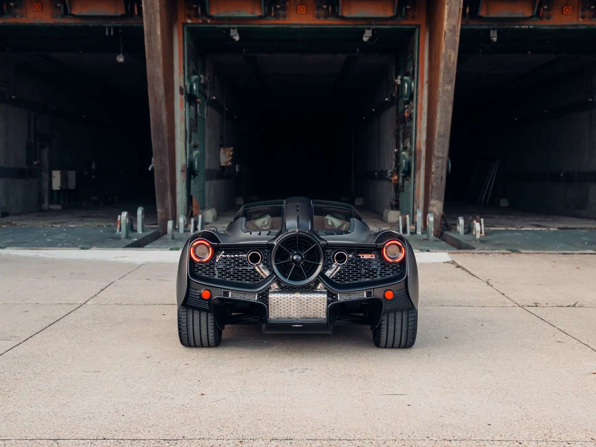 Rear view of Gordon Murray T.50 chassis 047 in front of an industrial building