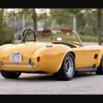 Why a Top Shelby Historian Chose to Build — Not Buy — This 427 S/C Cobra 482-Side-Oiler-Powered Kirkham Motorsports 427 S/C Cobra replica in Pearl Yellow, rear three-quarter view
