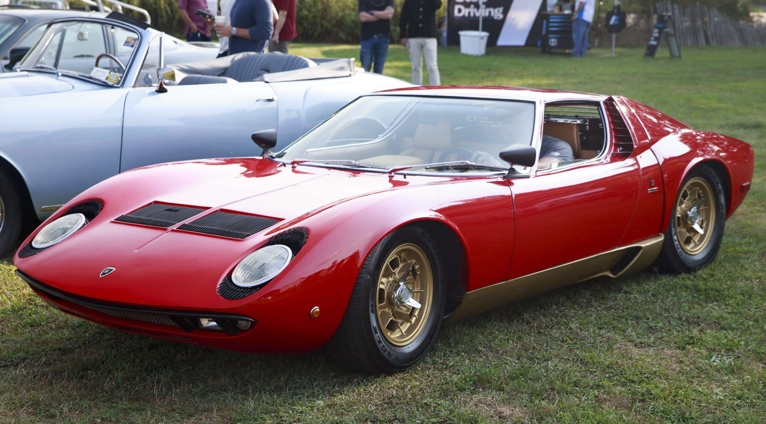 Lamborghini Miura P400S shown in red over gold, representative of the model's styling by Bertone's Marcello Gandini (not the actual auction car)