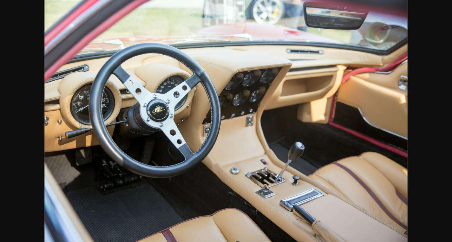 Lamborghini Miura P400 S cockpit and dashboard, showing the model's row of toggle switches and centrally mounted gauges