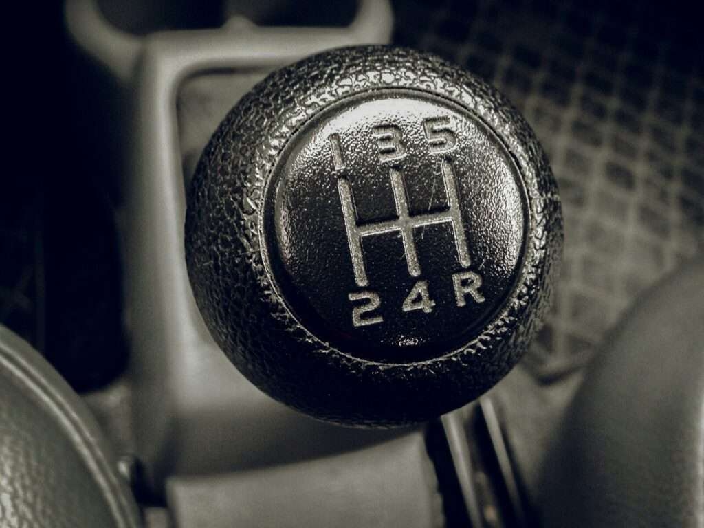 Close-up of a manual transmission gear shift knob and shift pattern