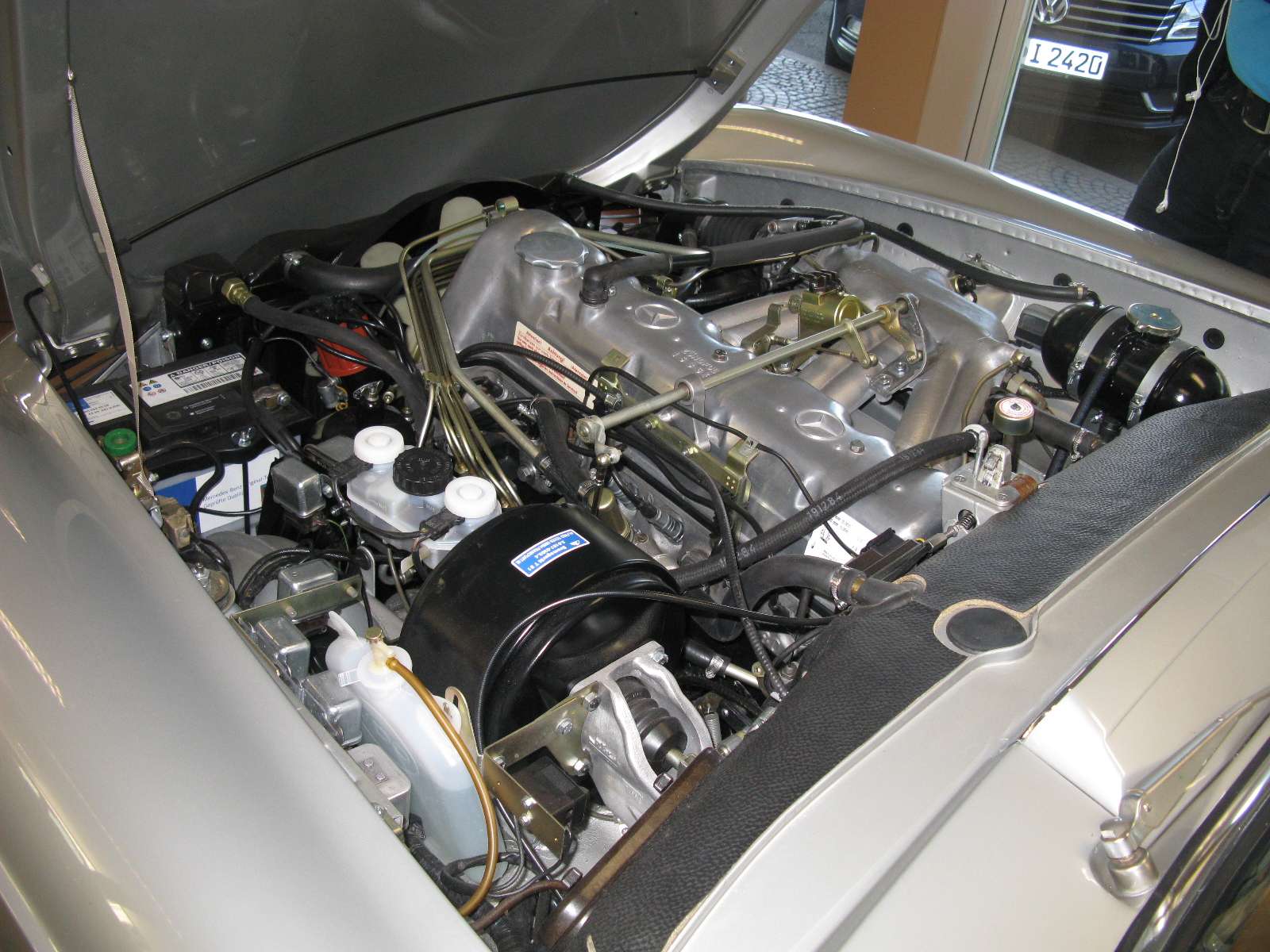 Engine bay of a Mercedes-Benz 280 SL W113 showing the M130 inline-six