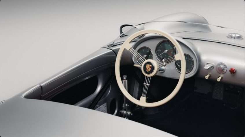 Cockpit of the Porsche 550 J showing its analog instruments and 550 Spyder-style steering wheel