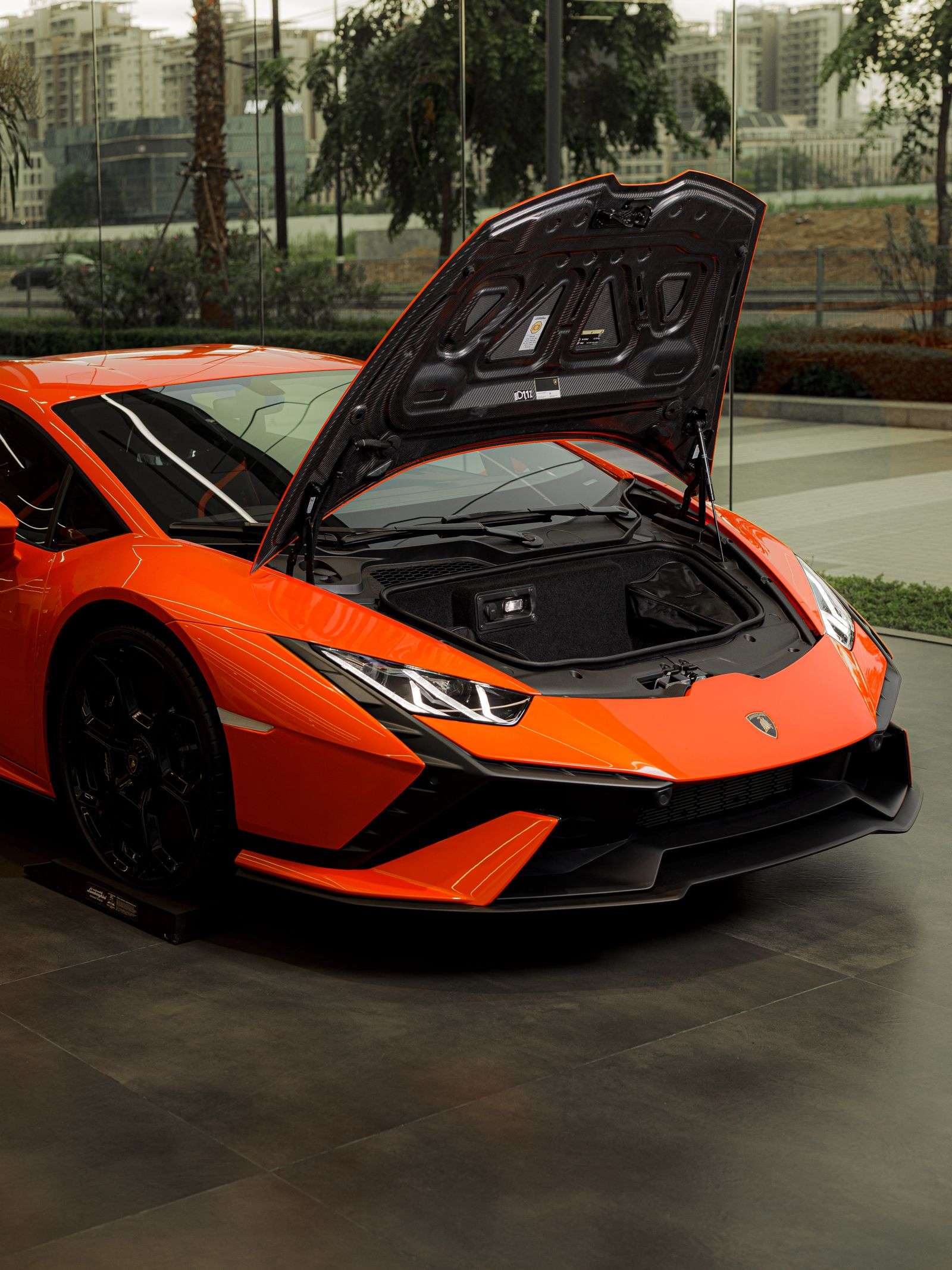 Orange mid-engined supercar viewed from the front