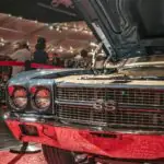 Barrett-Jackson's Las Vegas Auction Made $36 Million. The Two Best Cars in the Building Weren't For Sale. Classic blue car with hood open at an exhibition