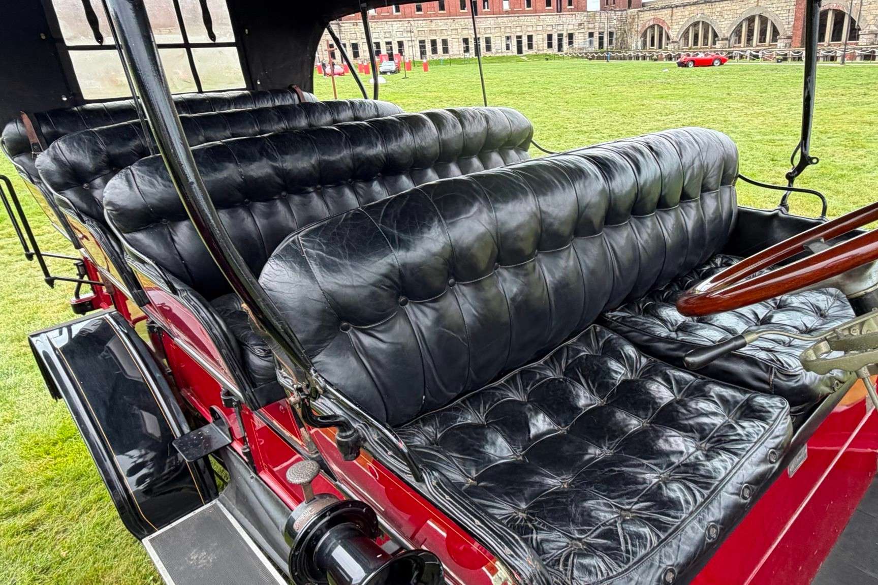Black tufted leather bench seats inside the 1913 Stanley Mountain Wagon, one of four three-place rows
