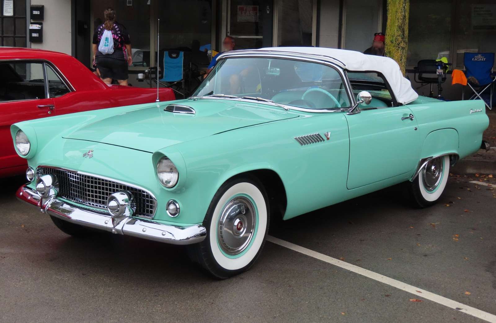 Light blue 1955 Ford Thunderbird with a white top and whitewall tires parked at a car cruise in New Brighton, Pennsylvania
