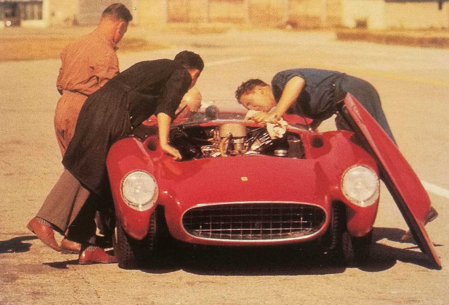Ferrari 335 at the Modena Aerautodromo in 1957 with Luigi Bazzi and mechanics