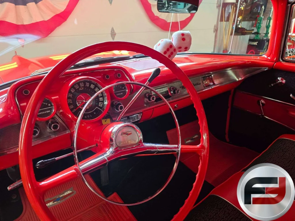 Red dashboard and steering wheel of the 1957 Chevrolet Bel Air