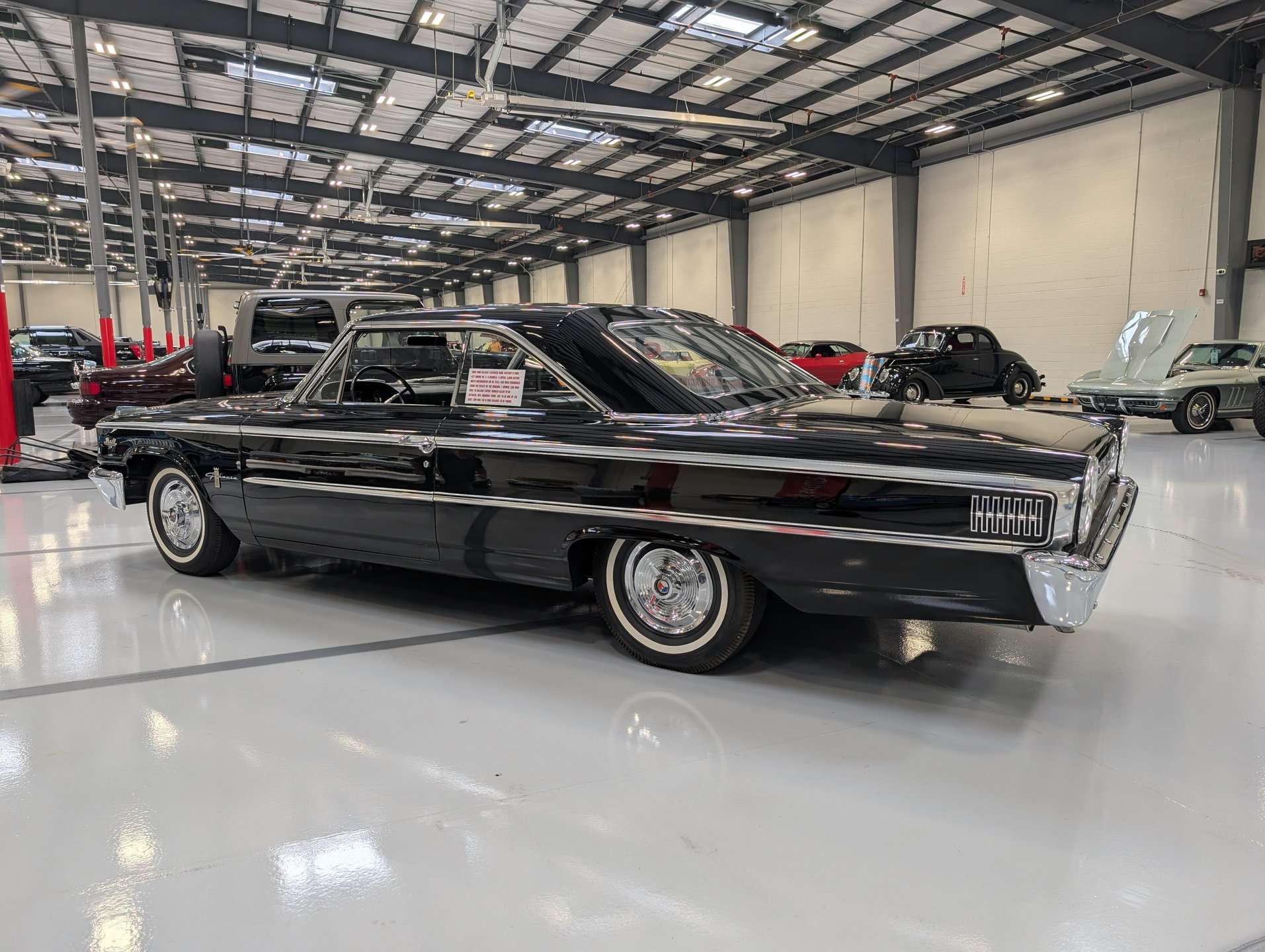 Side profile of the black 1963 Ford Galaxie fastback offered by GAA Classic Cars