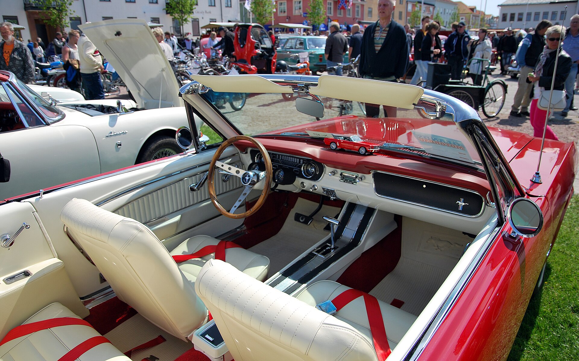 Interior of a 1965 Ford Mustang convertible showing the dashboard and bucket seats