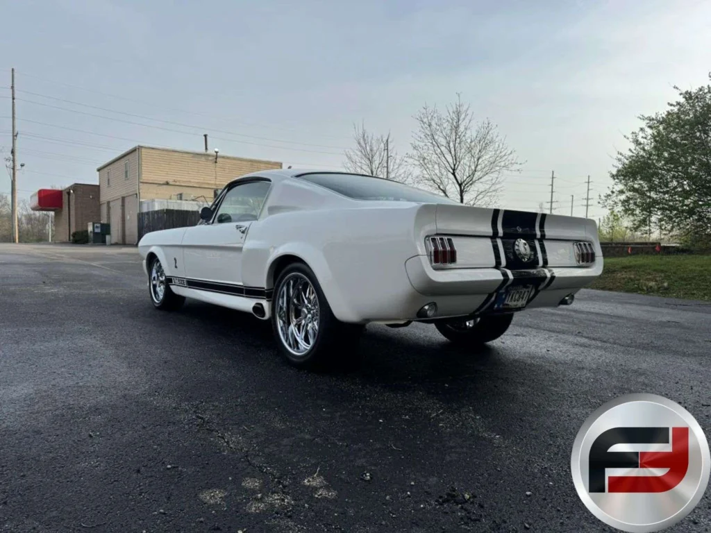 Rear three-quarter view of the white 1965 Mustang Eleanor tribute fastback outdoors