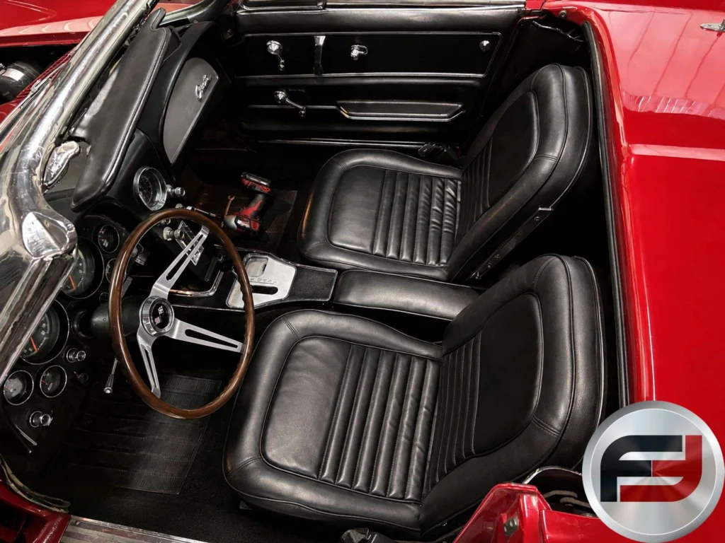Overhead view of the black bucket seats and wood-rim steering wheel in the 1966 Corvette