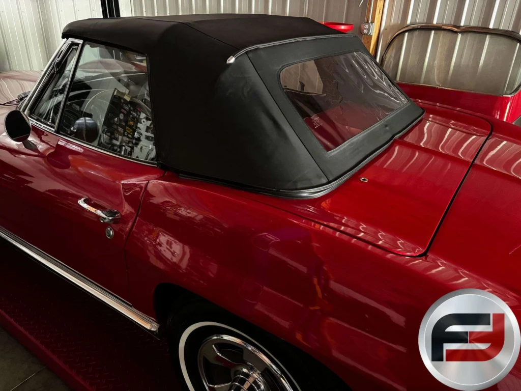 Black soft top raised on the red 1966 Corvette convertible