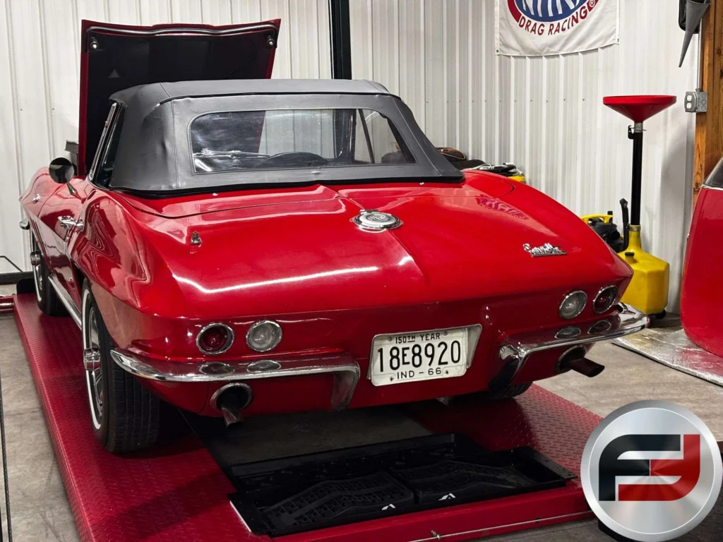 Rear view of the red 1966 Chevrolet Corvette convertible with its top up
