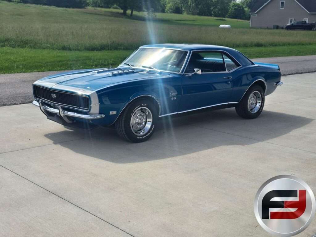 Blue 1968 Chevrolet Camaro SS coupe front three-quarter view on a concrete driveway