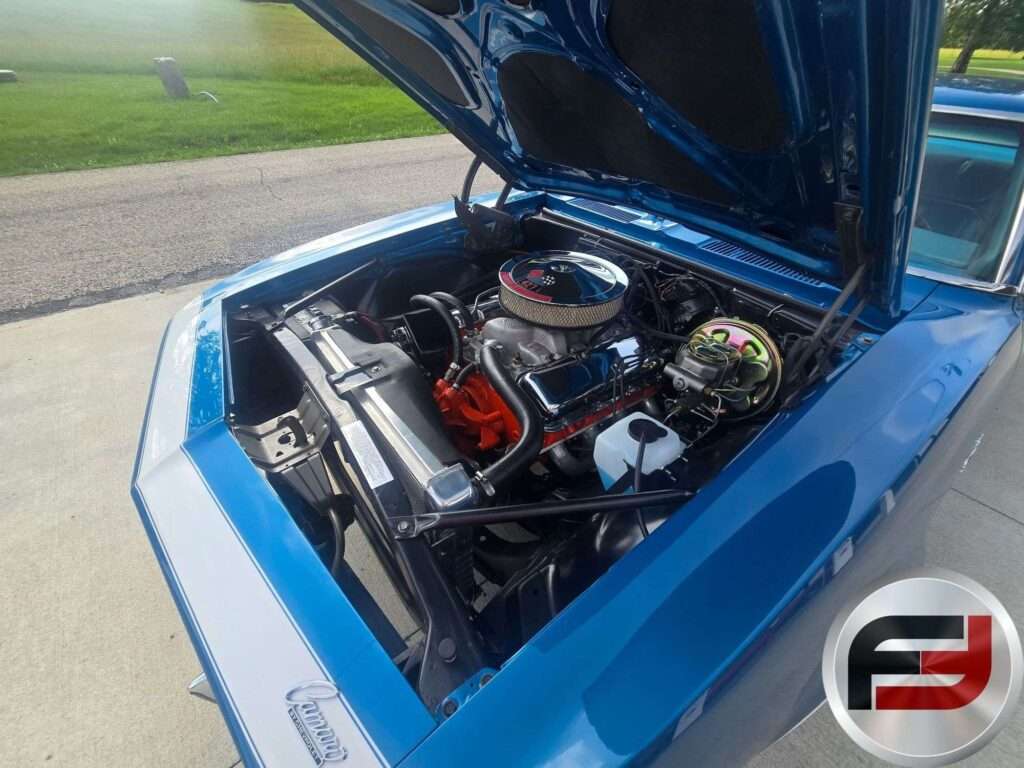 Passenger side view of the 1968 Camaro SS with the hood open in a driveway