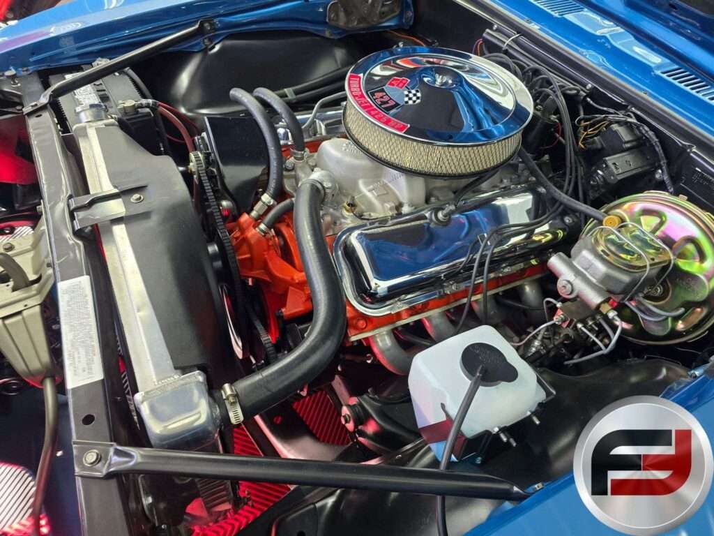 Orange 427 big-block V8 with chrome air cleaner in the engine bay of the 1968 Camaro SS