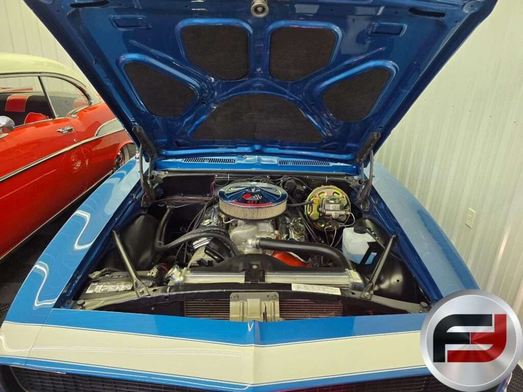 Front of the 1968 Camaro SS with hood raised showing the white nose stripe and big-block engine