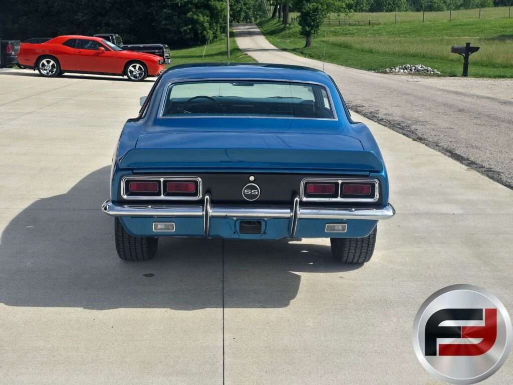 Rear view of the blue 1968 Camaro SS on a concrete driveway