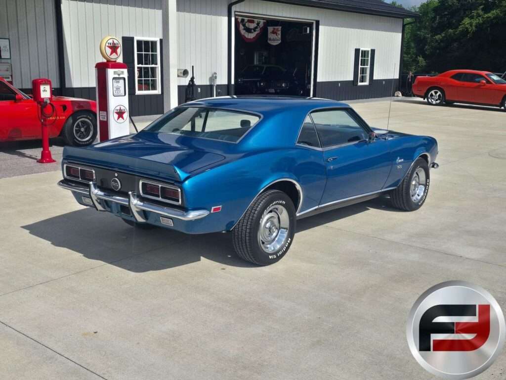 Rear three-quarter view of the blue 1968 Camaro SS with chrome bumper and taillights