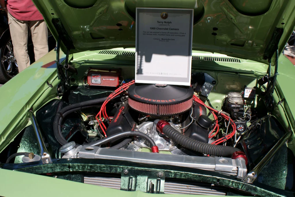 Engine bay of a green 1969 Camaro Z/28 with a 302 V8 and aftermarket air cleaner