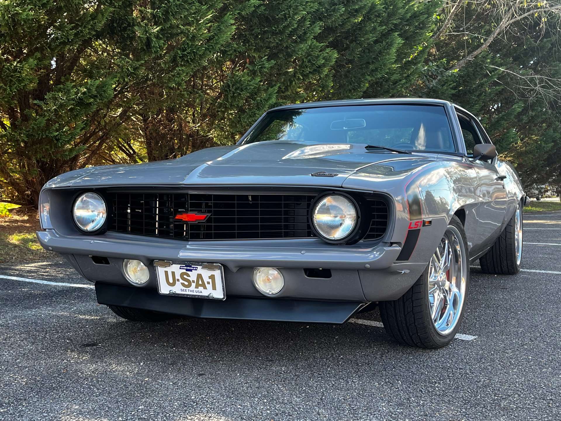Front view of the gray 1969 Chevrolet Camaro with black grille and red bowtie emblem