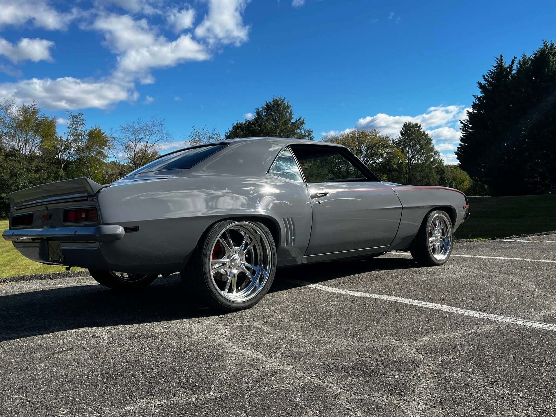 Rear three-quarter view of the 1969 Camaro under a blue sky