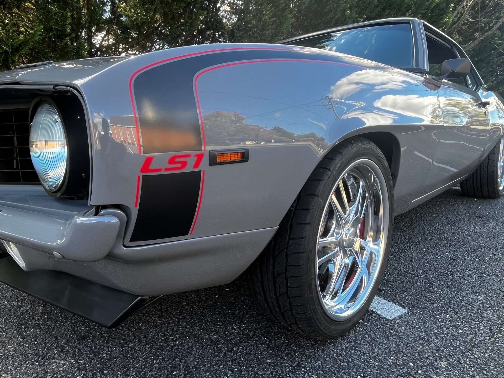Close-up of the 1969 Camaro front fender, black stripe and billet wheel