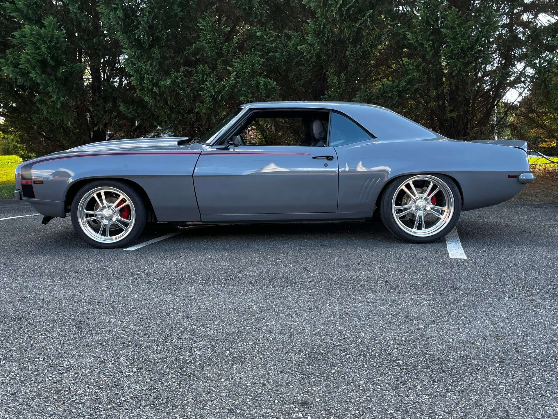 Side profile of the gray 1969 Chevrolet Camaro showing custom billet wheels