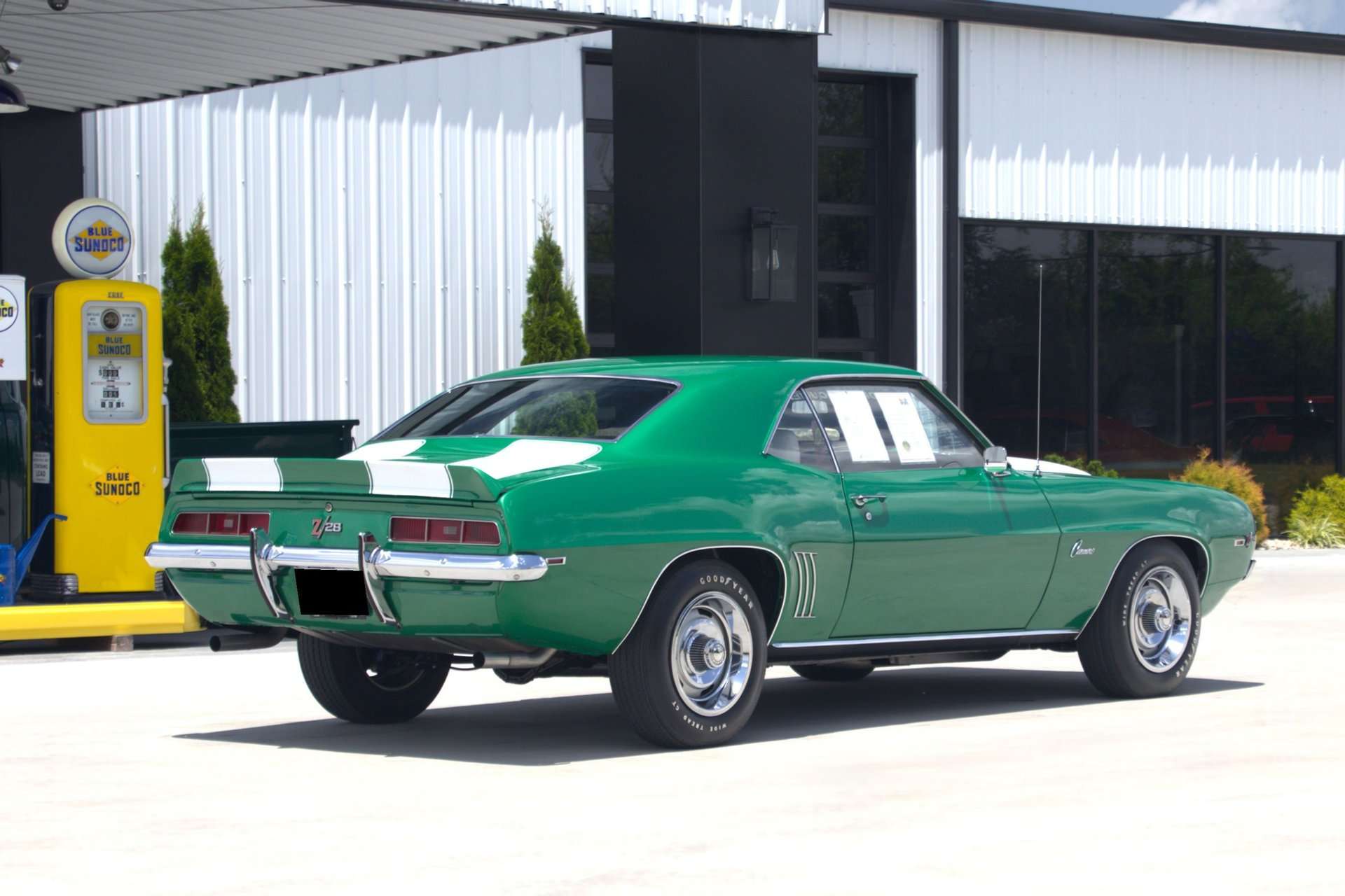 1969 Camaro Z/28 rear quarter view beside a vintage gas pump