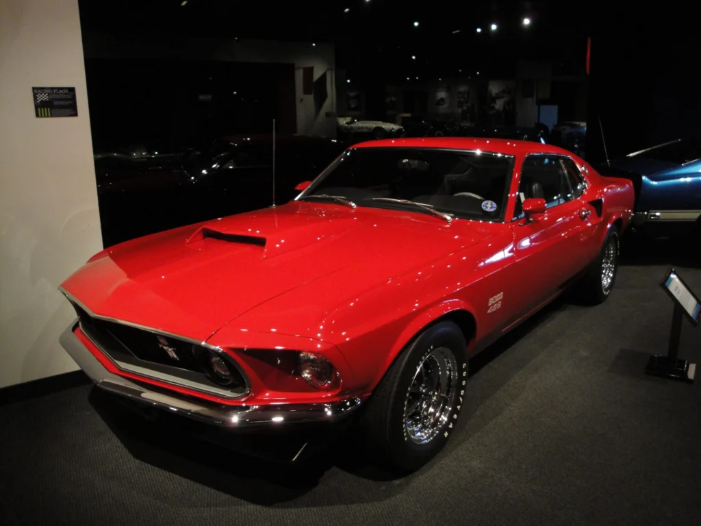 1969 Ford Mustang Boss 429 fastback with the large hood scoop, parked outdoors