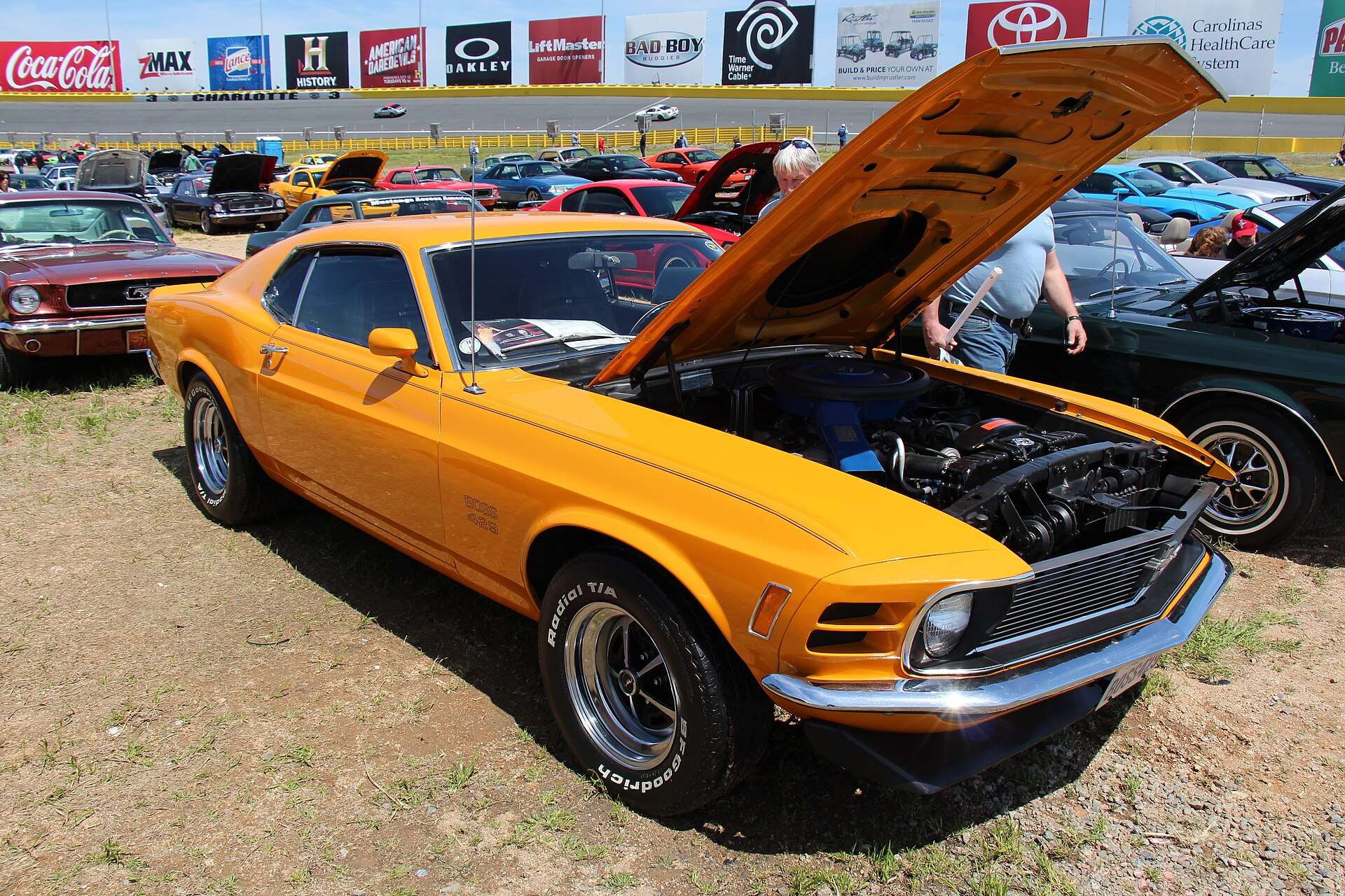 Grabber Orange 1970 Ford Mustang Boss 429 with hood open at a car show