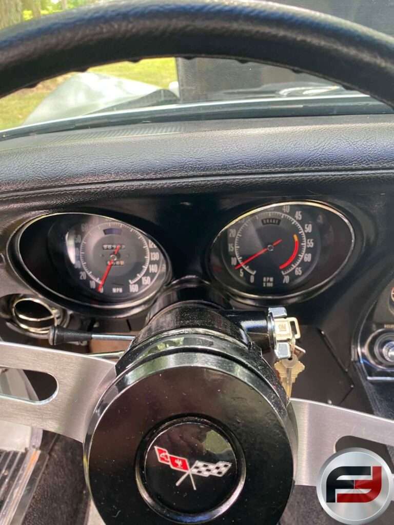 Speedometer and tachometer behind the steering wheel of the 1972 Corvette