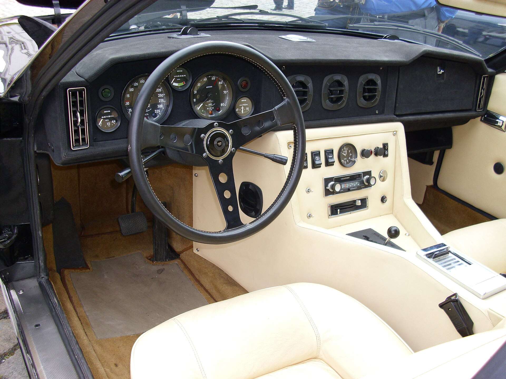 Interior of a 1972 Monteverdi 375/4 limousine with leather seats and wood-trimmed dashboard