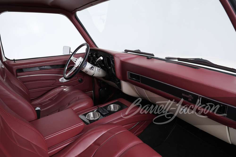 Burgundy leather bucket-seat interior with custom console and billet steering wheel in a 1982 Chevrolet C10