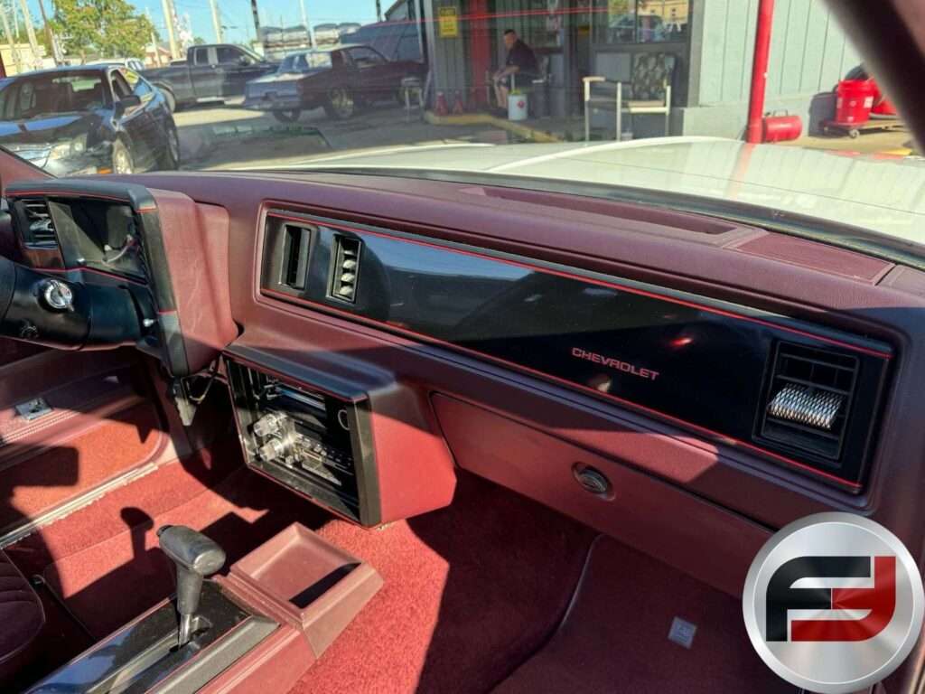 Maroon dashboard with Chevrolet script in the 1987 Monte Carlo SS Aerocoupe