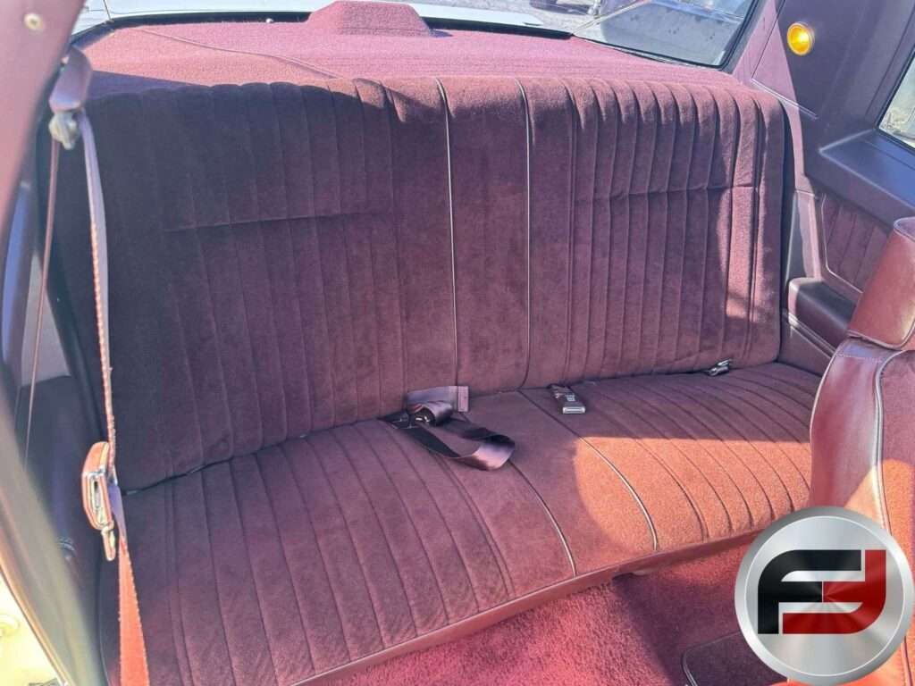 Maroon rear bench seat in the 1987 Chevrolet Monte Carlo SS Aerocoupe