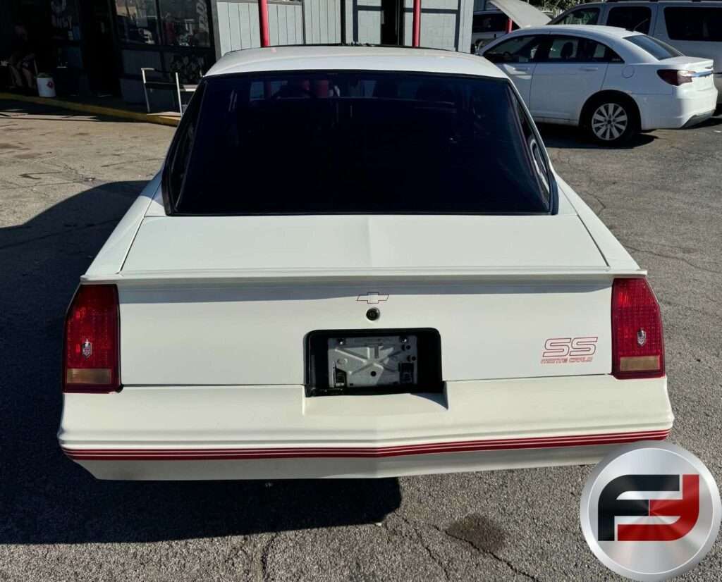 Rear view of the white 1987 Monte Carlo SS Aerocoupe showing its rear spoiler and SS badge