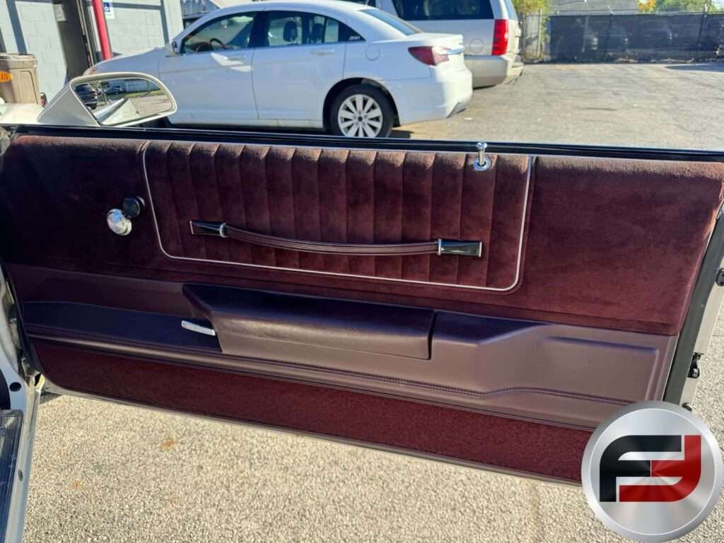 Passenger door panel with maroon velour trim in the 1987 Monte Carlo SS Aerocoupe