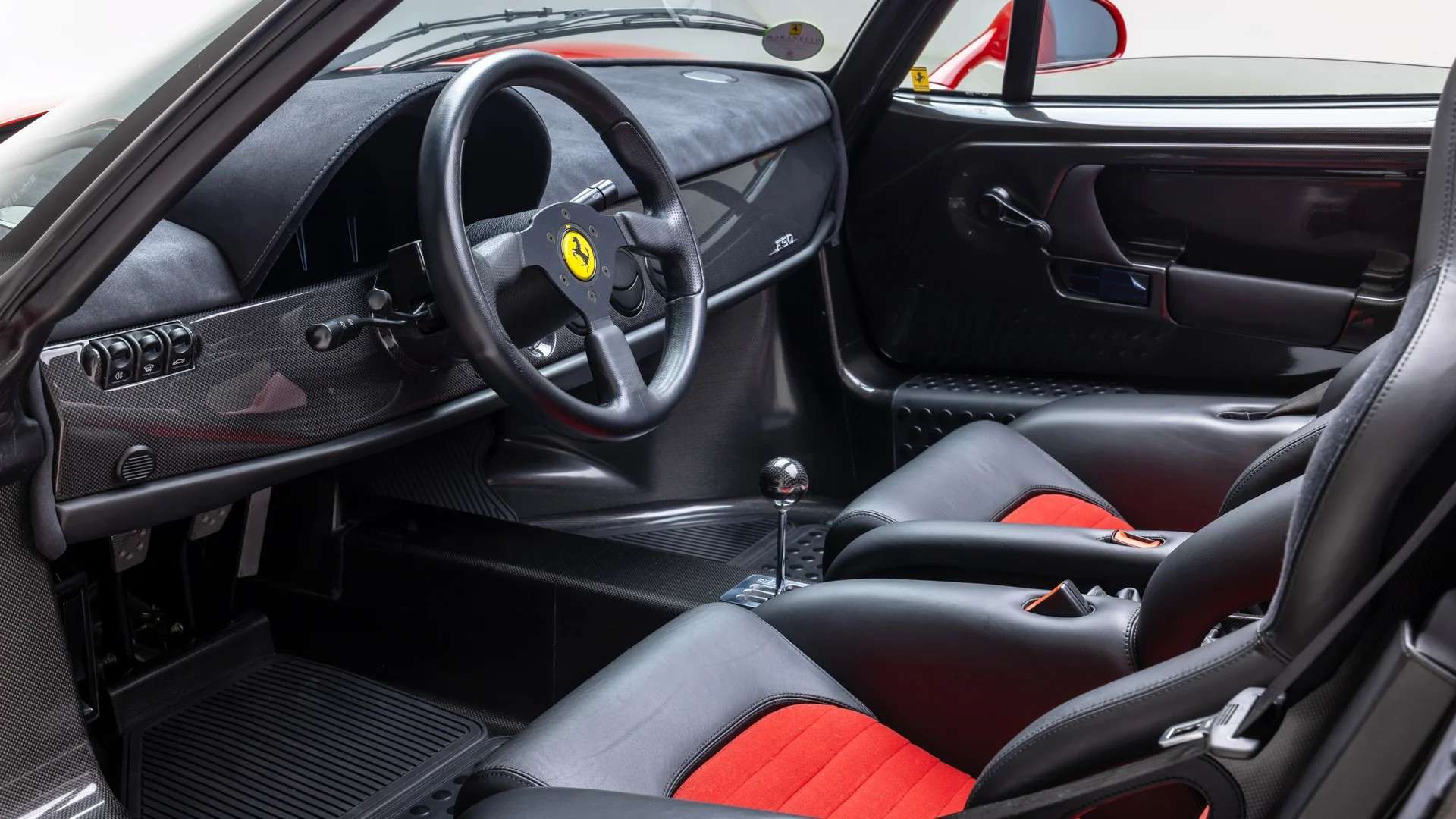 Nero leather and Rosso seat inserts inside the 106-mile 1997 Ferrari F50