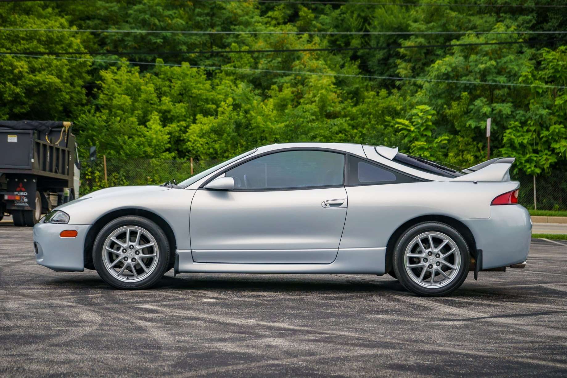 Silver 1998 Mitsubishi Eclipse GSX coupe with a rear wing photographed from the side