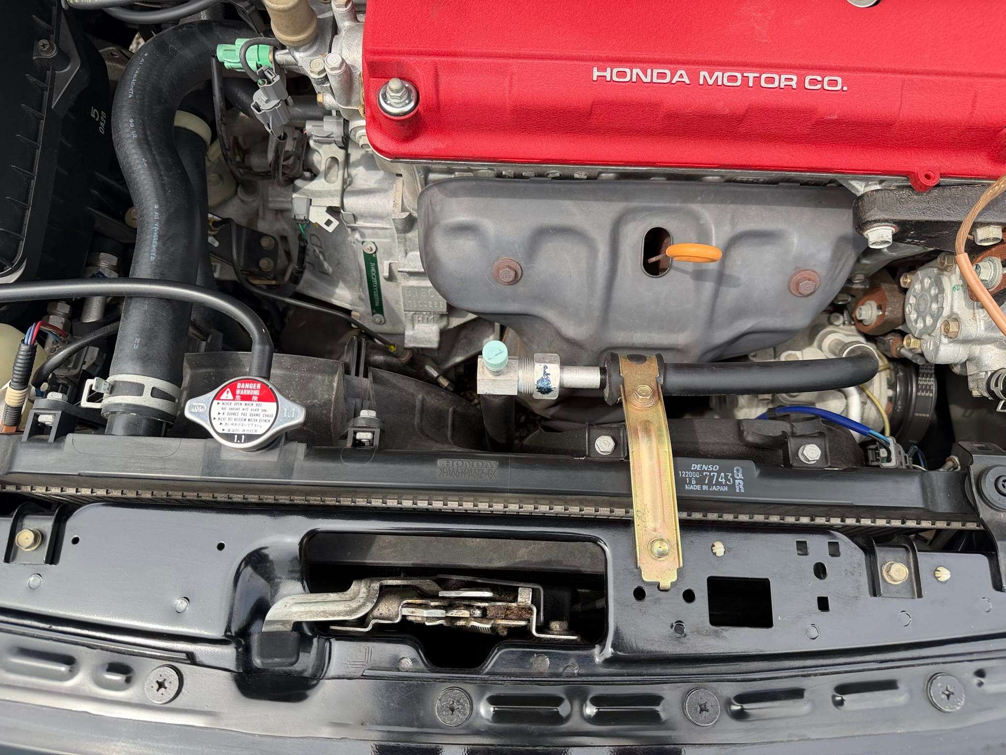 B18C5 VTEC engine with red valve cover in the engine bay of a 2000 Acura Integra Type R