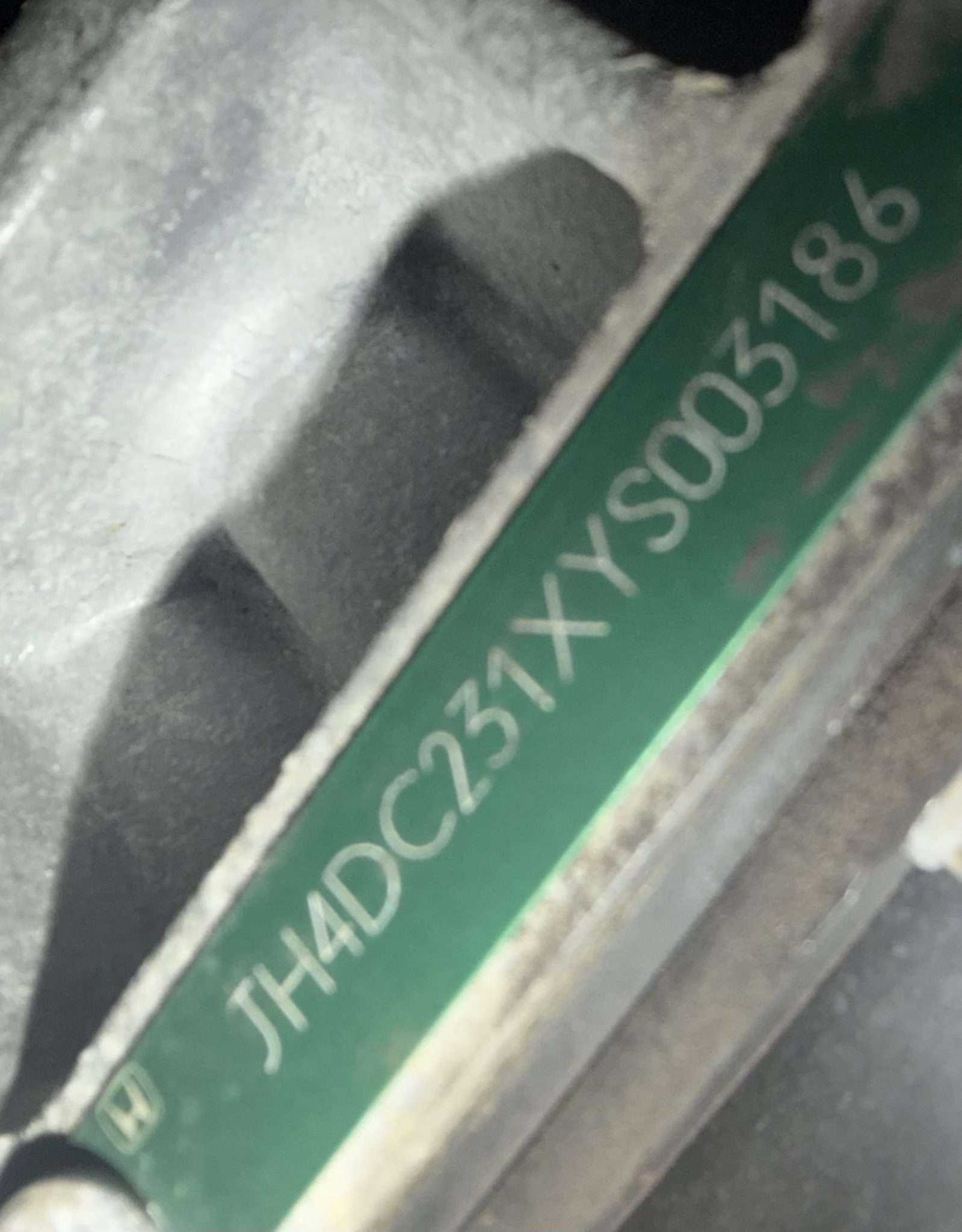 Green VIN tag on the powertrain of a 2000 Acura Integra Type R showing the JH4DC231 VIN prefix
