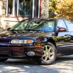 Is the Oldsmobile Aurora Final 500 a Future Collector Car? The Last 500 Don’t Trade Alike 2003 Oldsmobile Aurora Final 500 in Dark Cherry Metallic seen from the front three-quarter angle