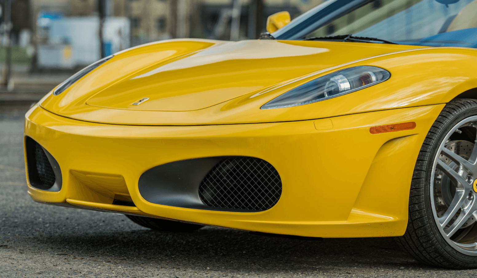 Close view of the yellow Ferrari F430 Spider front fascia and alloy wheel