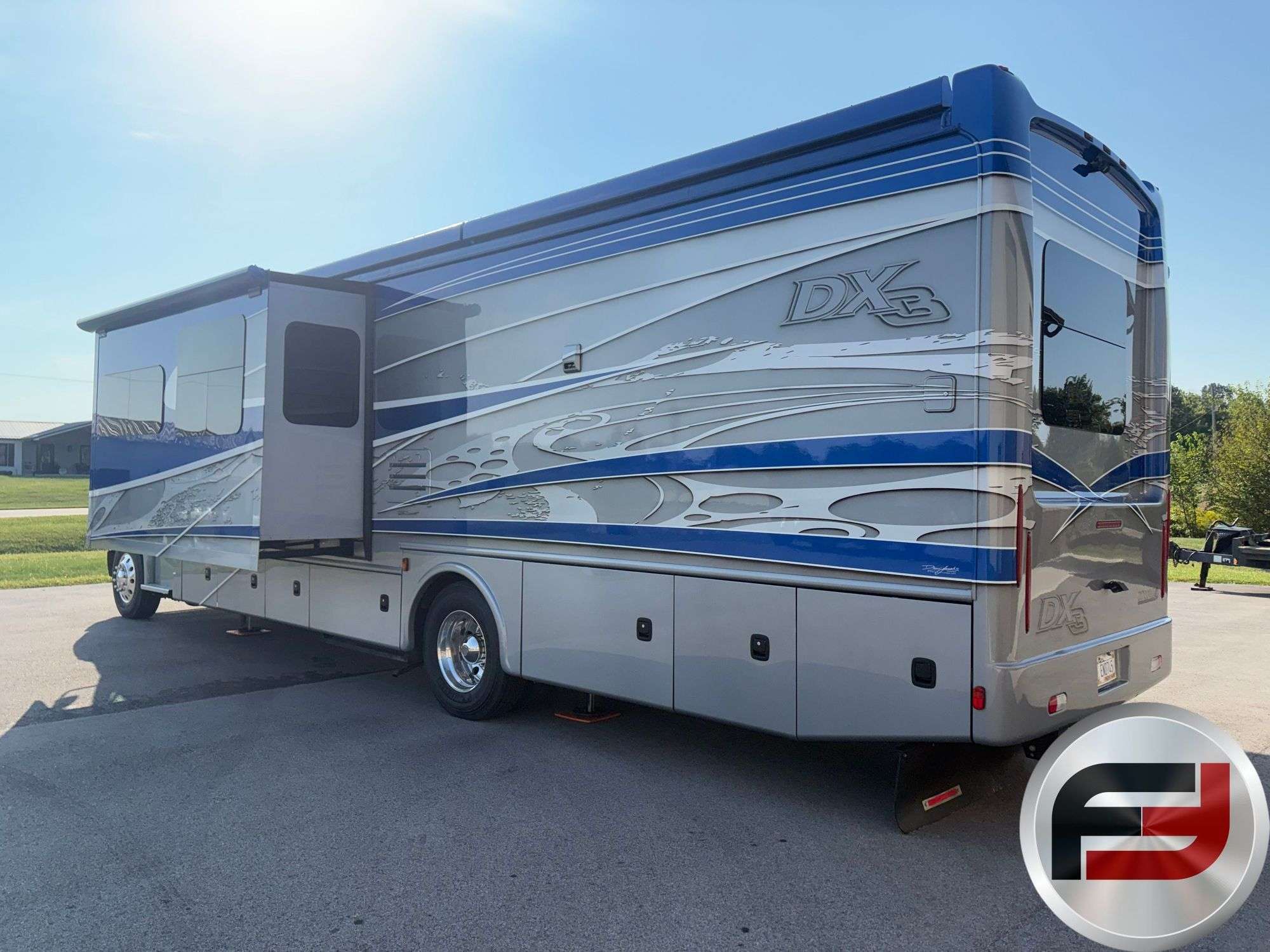 Rear three-quarter view of the 2017 Dynamax DX3 37TS custom paint and slide-out